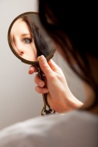 13204669 - closeup of a mirror reflection of a woman's eye, selective focus